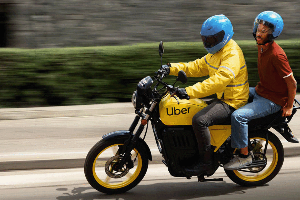 This is a picture of a Ubber motorcycle ferrying a passenger