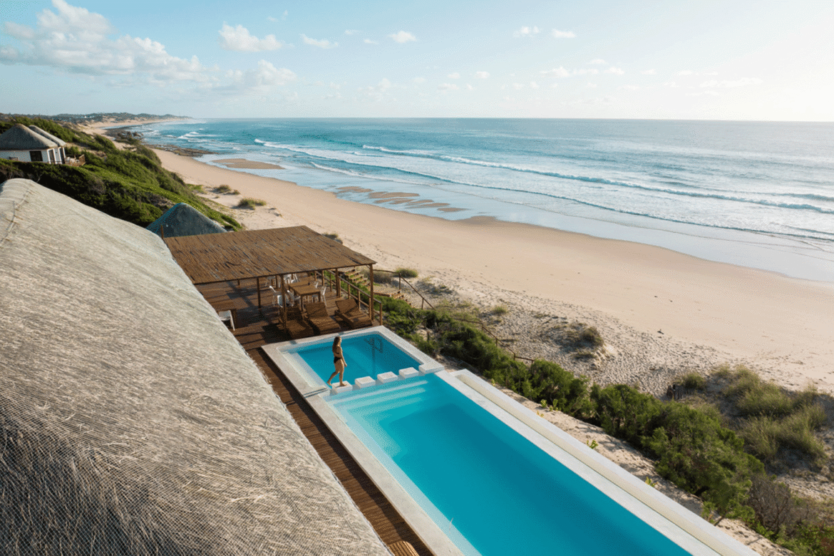 A sceneic picture of a sea shore with an infinity pool